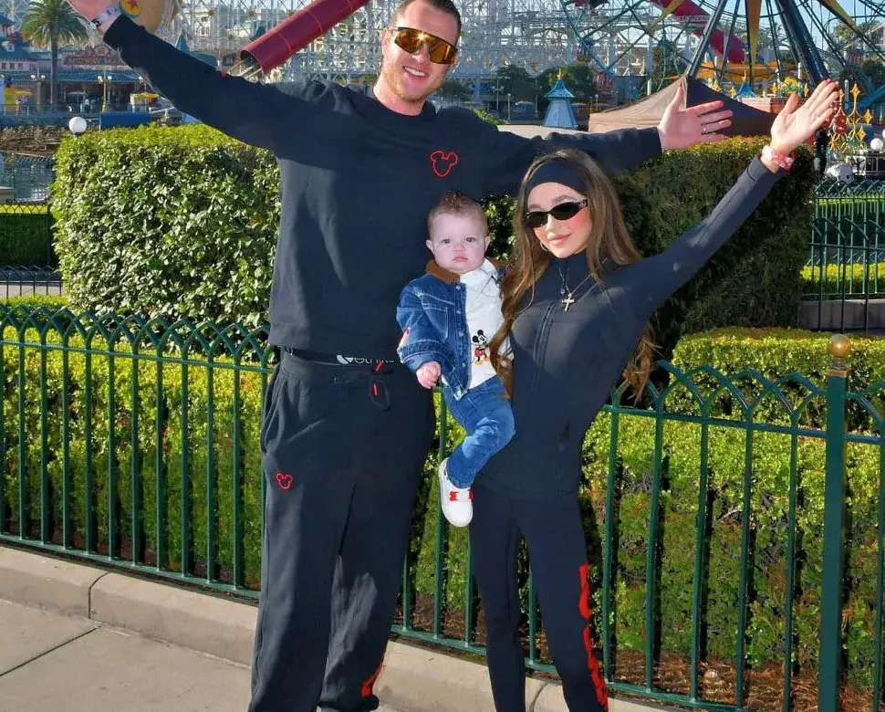 Alex Stewart Jr. with his wife and their young son